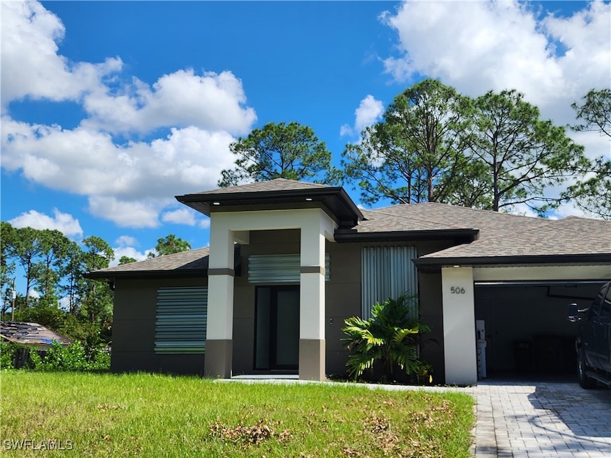 View of front of home with a garage and a front la