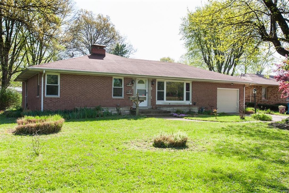 Classic low slung roofline shelters this brick ranch