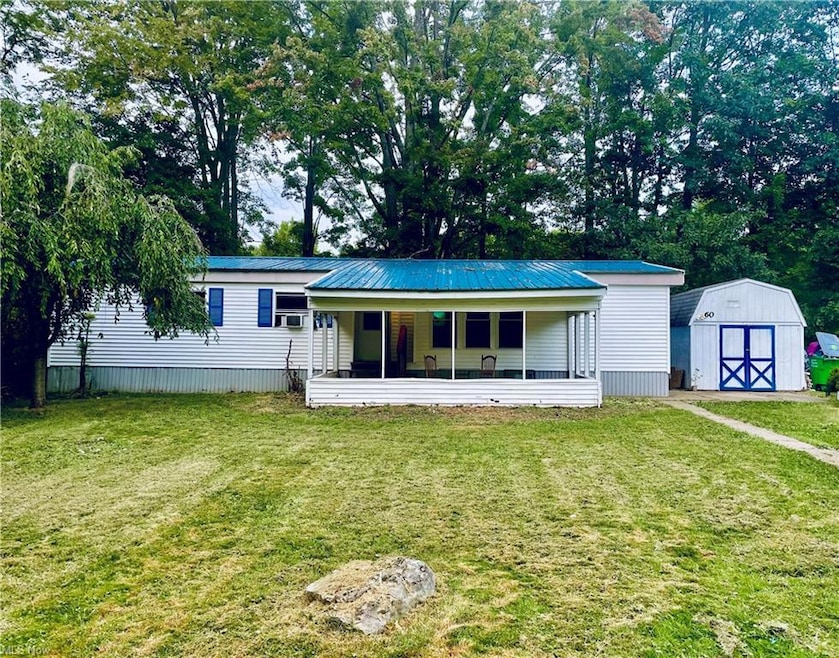 View of front of house featuring a shed, a porch, 