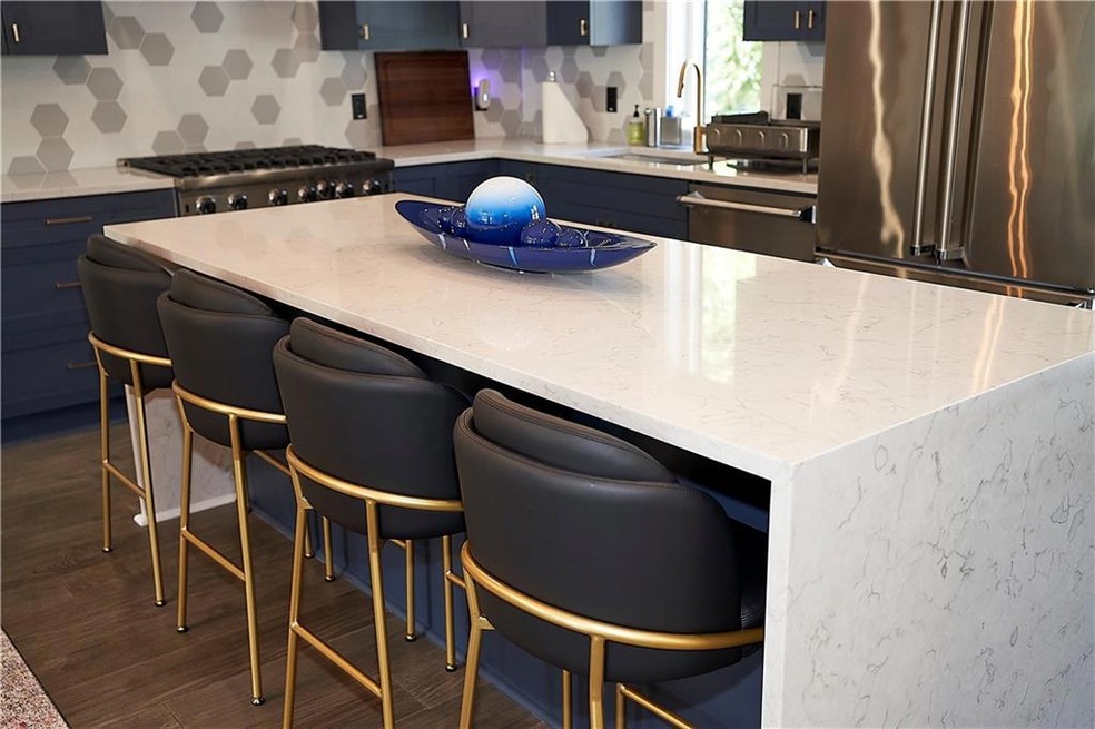 Kitchen featuring a kitchen island, appliances wit