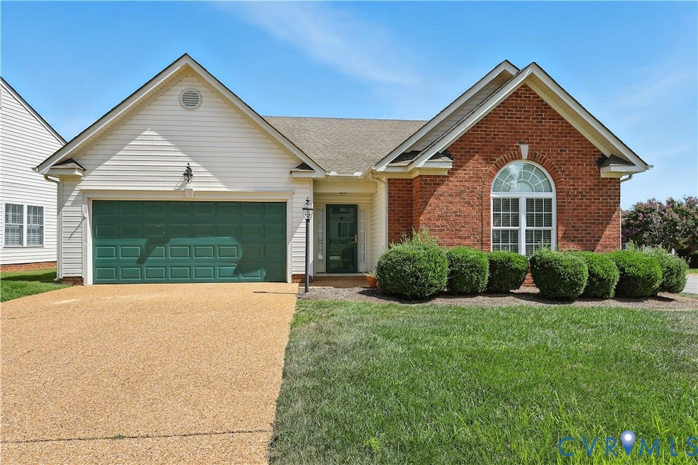Single story home featuring concrete driveway, a garage, brick siding, a front lawn, and roof with shingles