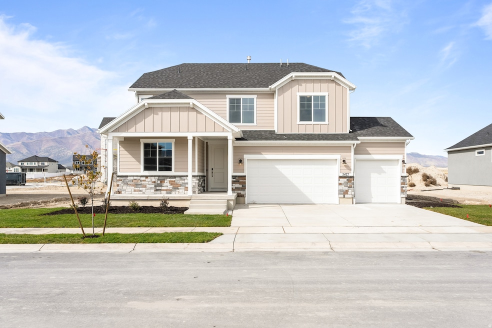 Craftsman house featuring board and batten siding, a porch, stone siding, a mountain view, and concrete driveway