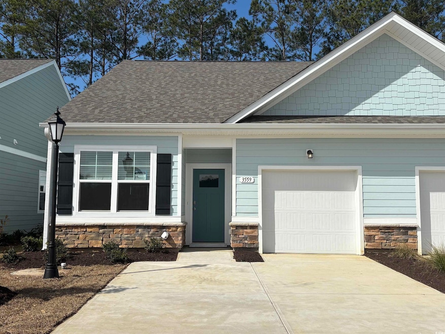 View of front of house featuring a garage, concret