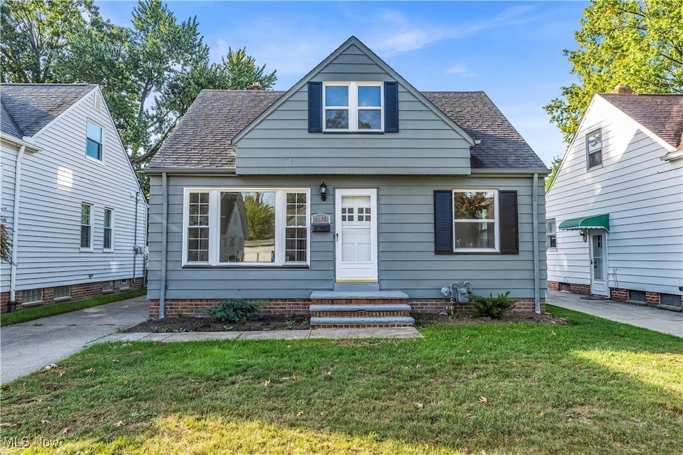 View of front of house featuring roof with shingles and a front lawn