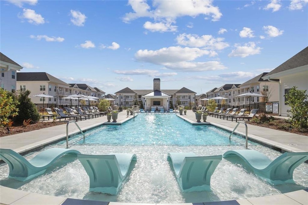 View of pool featuring pool water feature and a pa
