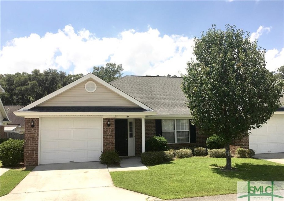 Beautiful brick townhome with garage. Lush landsca