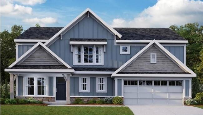 Craftsman-style house featuring a garage and a fro