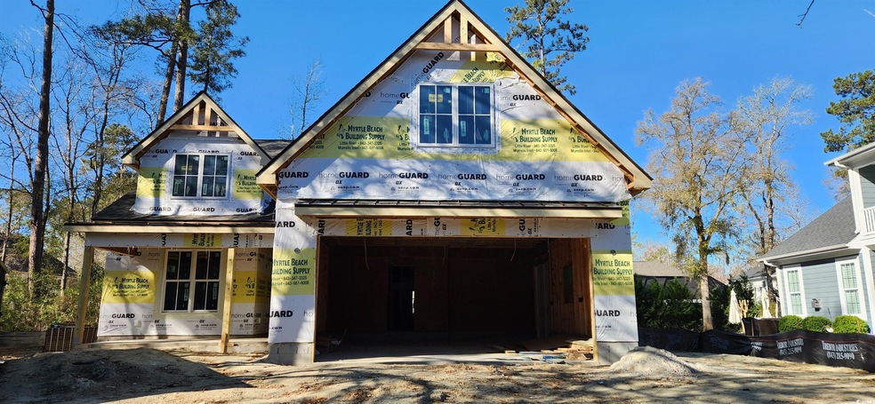Unfinished property featuring a garage