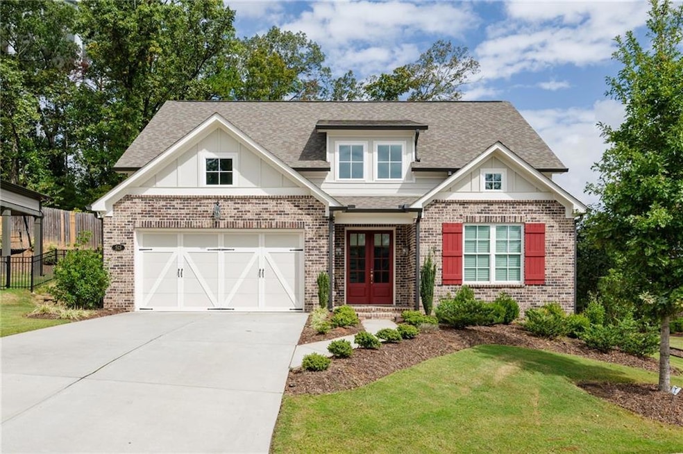 Craftsman-style home with brick siding, roof with shingles, concrete driveway, and board and batten siding