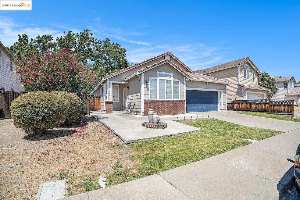 View of front of property featuring brick siding, driveway, and a garage