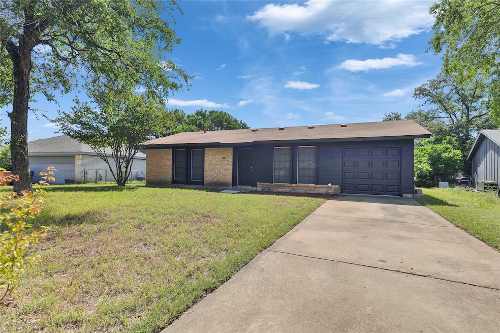 Single story home with an attached garage, drivew