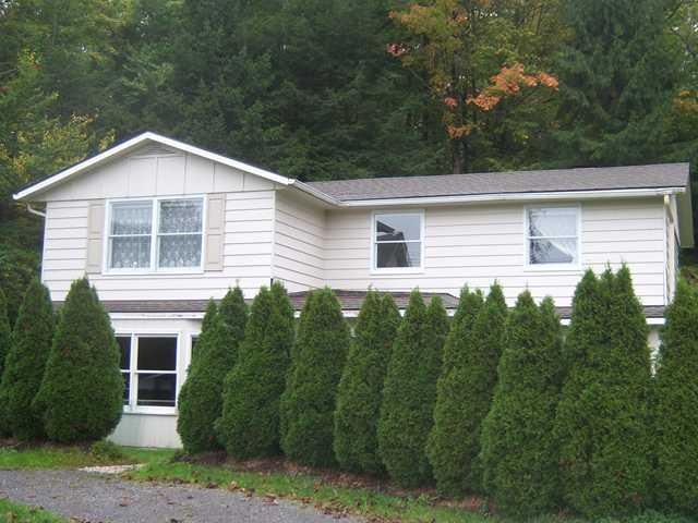 Exterior Front. Set back from the road and nestled