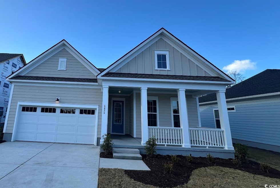View of front of property featuring a garage and c