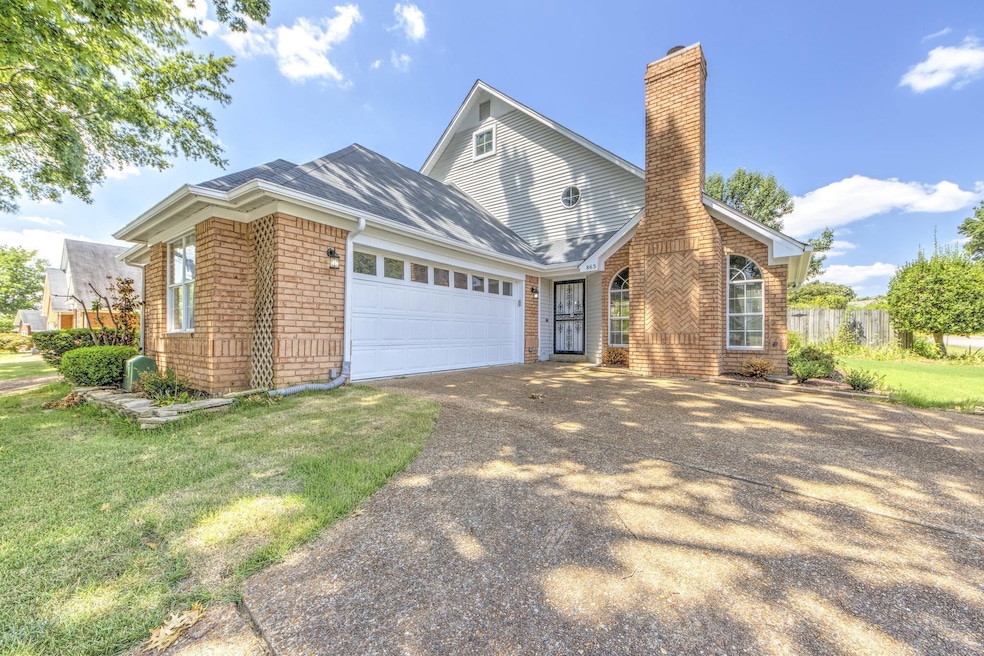 Exterior space featuring a garage and a yard