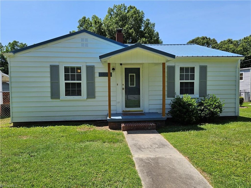 Charming ranch home with 4 car detached garage. Exterior recently painted. Metal roof.