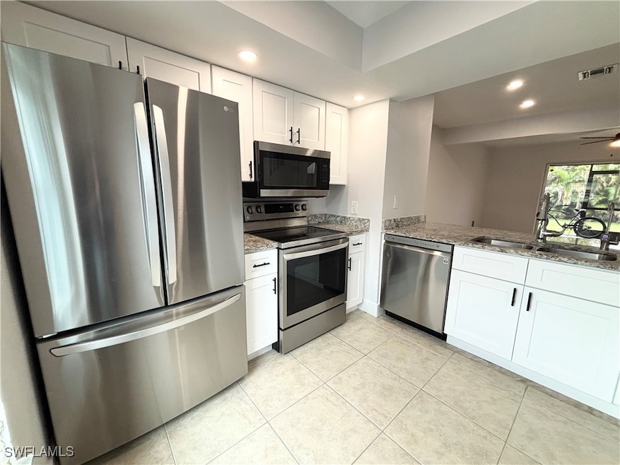 Kitchen with stainless steel appliances, light sto