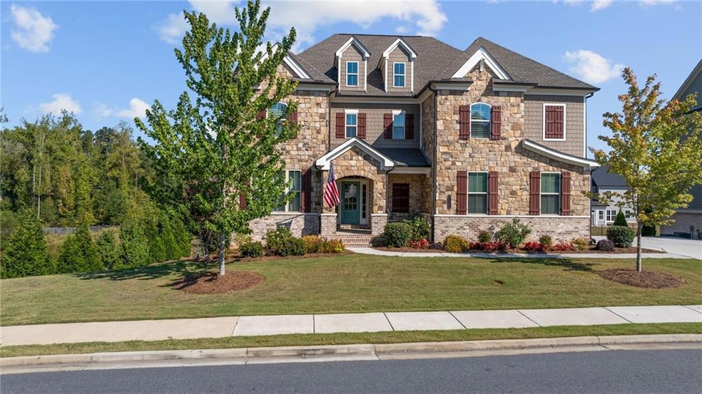 Craftsman house with stone siding and a front yard