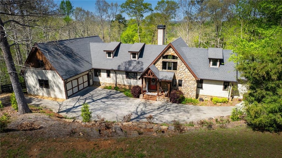 Rear view of property featuring a shingled roof, a