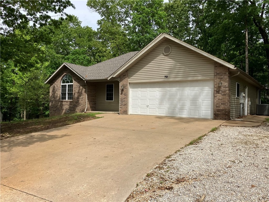 Front of home with plenty of parking