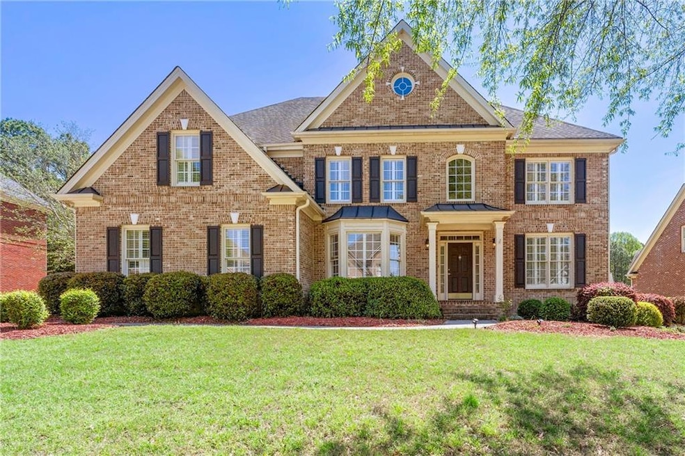 Colonial inspired home featuring brick siding and 