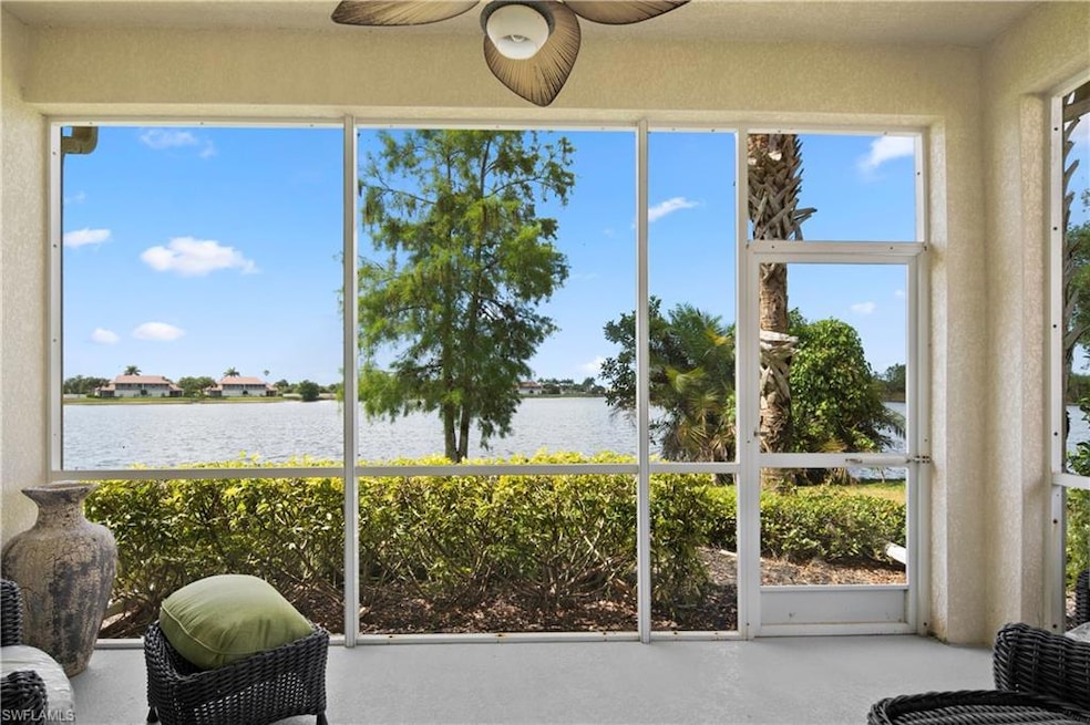 Sunroom featuring a water view and a ceiling fan