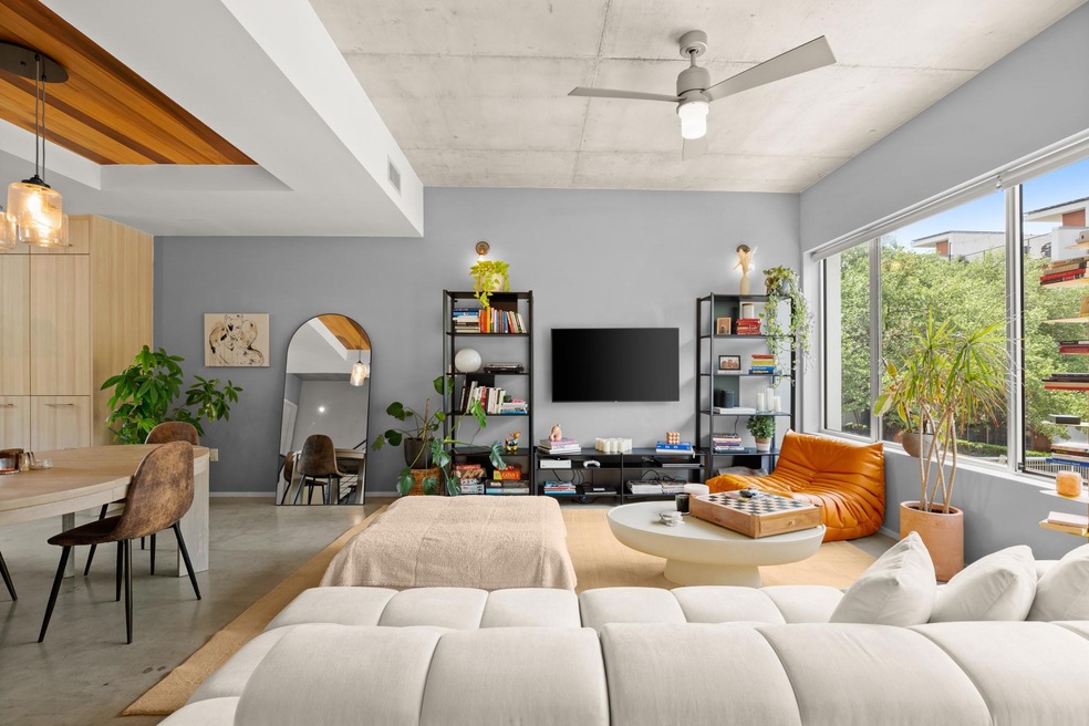 Living room with visible vents, ceiling fan, and 