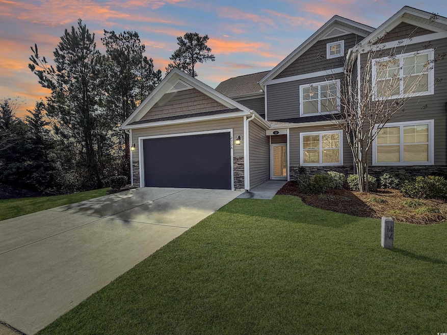 Craftsman-style home featuring a garage and a lawn