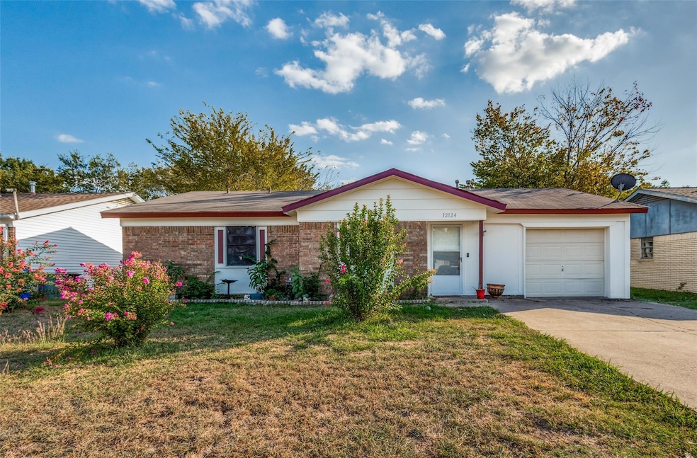 Ranch-style house featuring a front yard and a gar