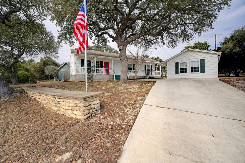 Single story home featuring covered porch and dri