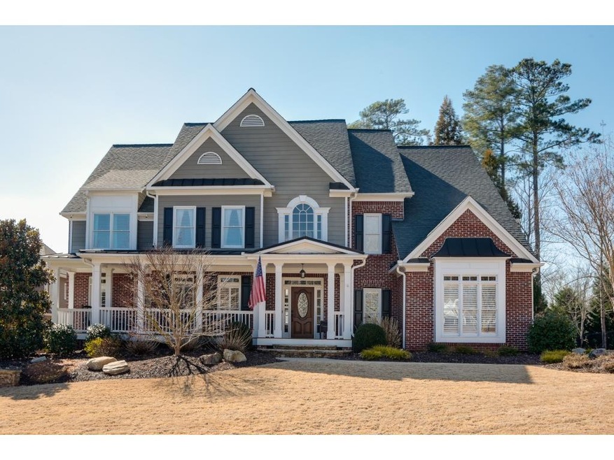 Captivating 3 Sided Brick Home Features a 3 Car Si