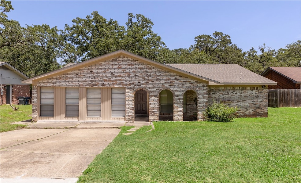 View of front of house with brick siding and roof