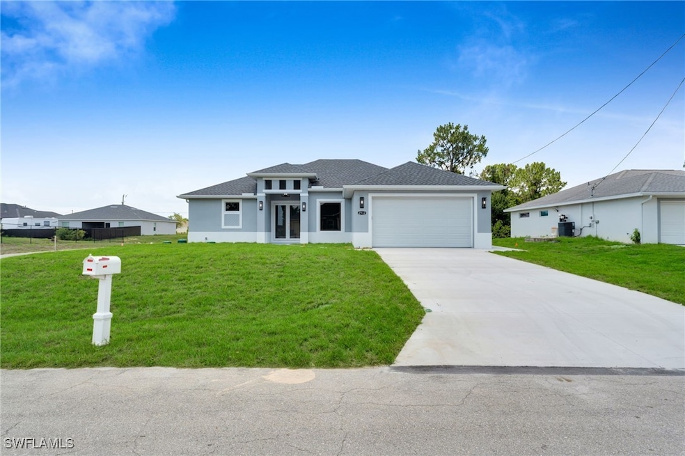 Prairie-style home featuring stucco siding, a gara