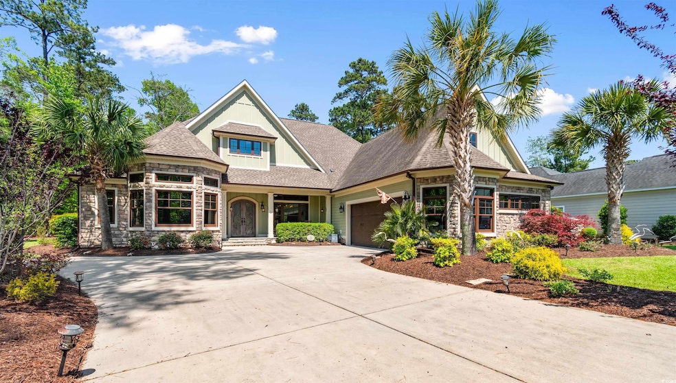 View of front of house featuring concrete driveway, stone siding, a shingled roof, and a garage
