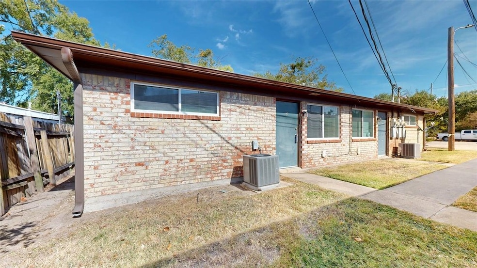 Rear view of property featuring brick siding