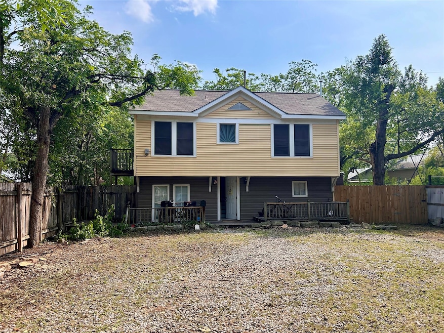 Back of house with a fenced backyard and a wooden