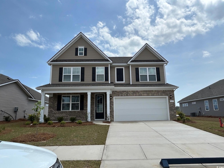 Craftsman-style home with a front lawn, driveway, 