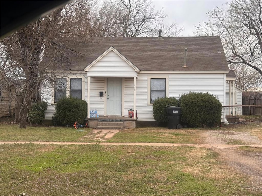 View of front of property with a shingled roof and a front yard