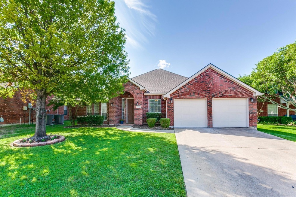 View of front of property with a garage and a front yard