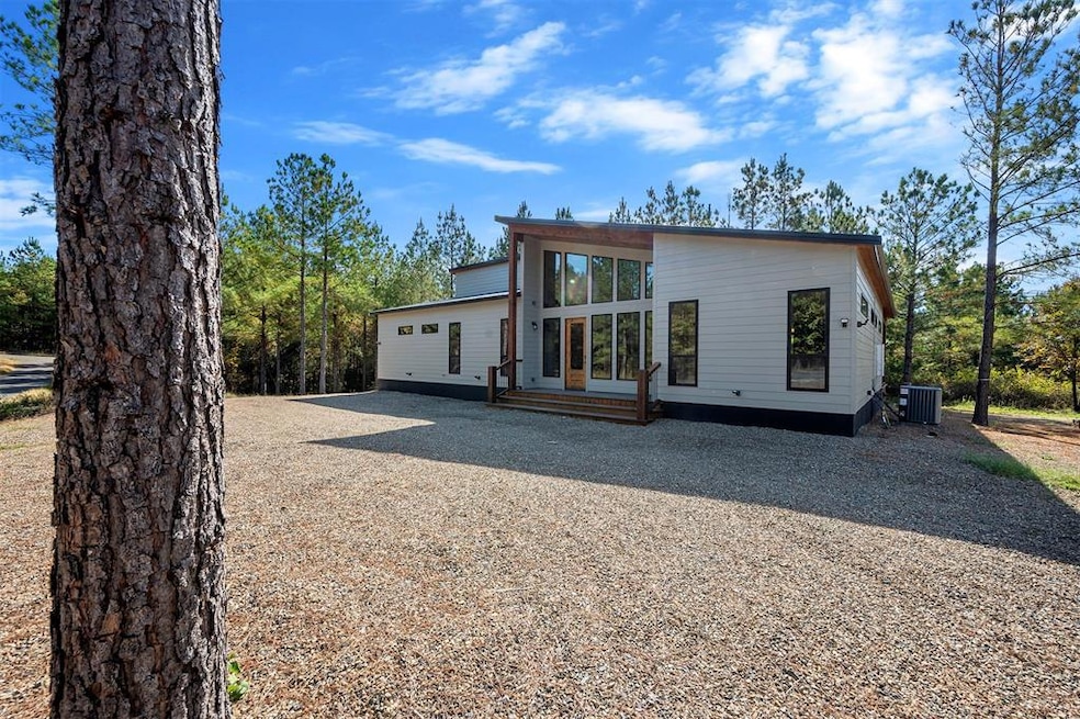 Modern home with driveway and a wooden deck