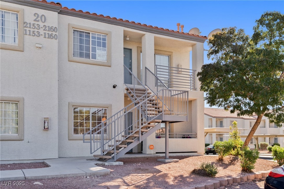 Doorway to property featuring stucco siding and a tile roof