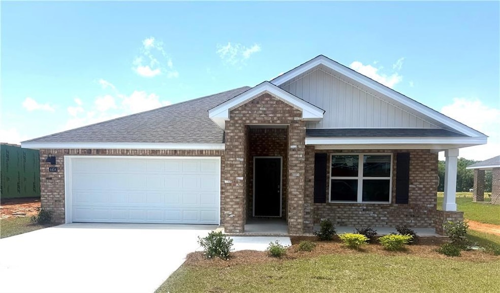 View of front of home featuring driveway, brick si