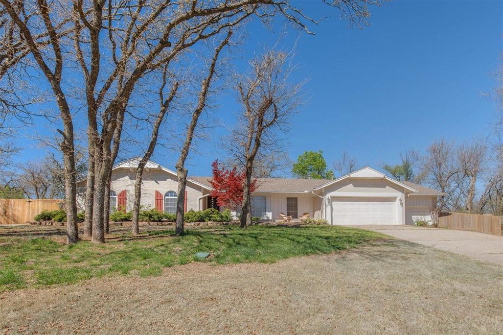 Ranch-style house featuring a garage and a front y