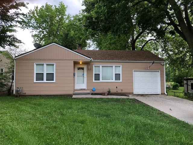 FRONT OF HOUSE WITH ONE CAR GARAGE AND NEWER DRIVE