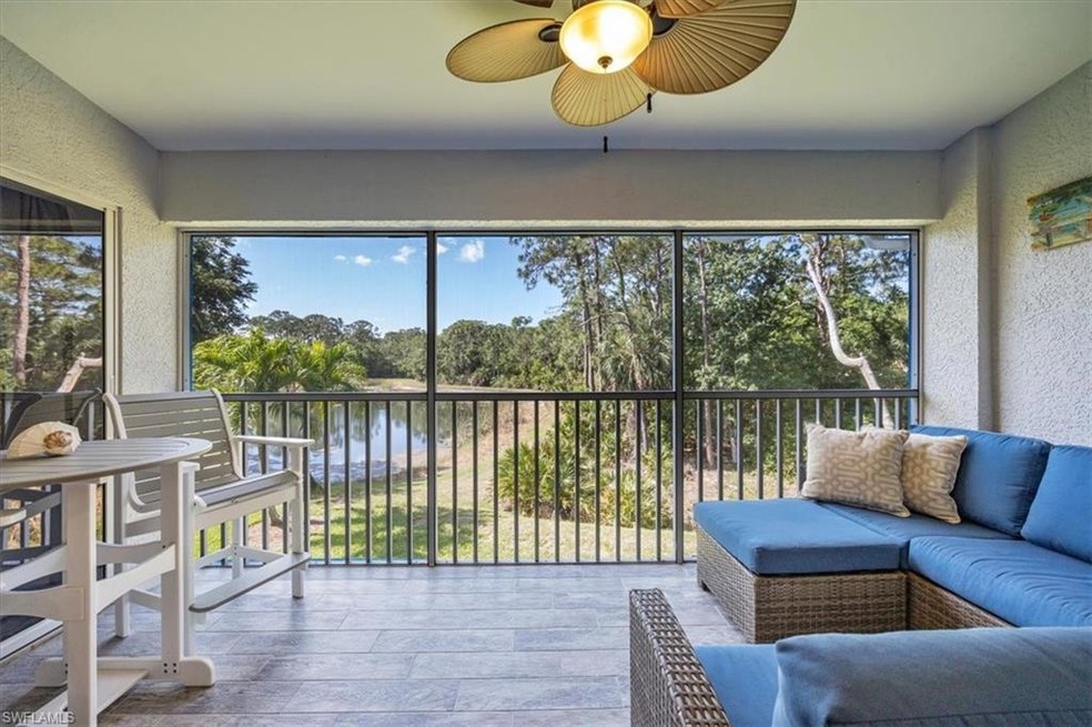 Sunroom featuring a water view