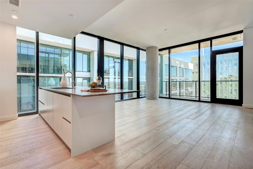 Kitchen with expansive windows, white cabinetry, modern cabinets, light wood-style flooring, and open floor plan