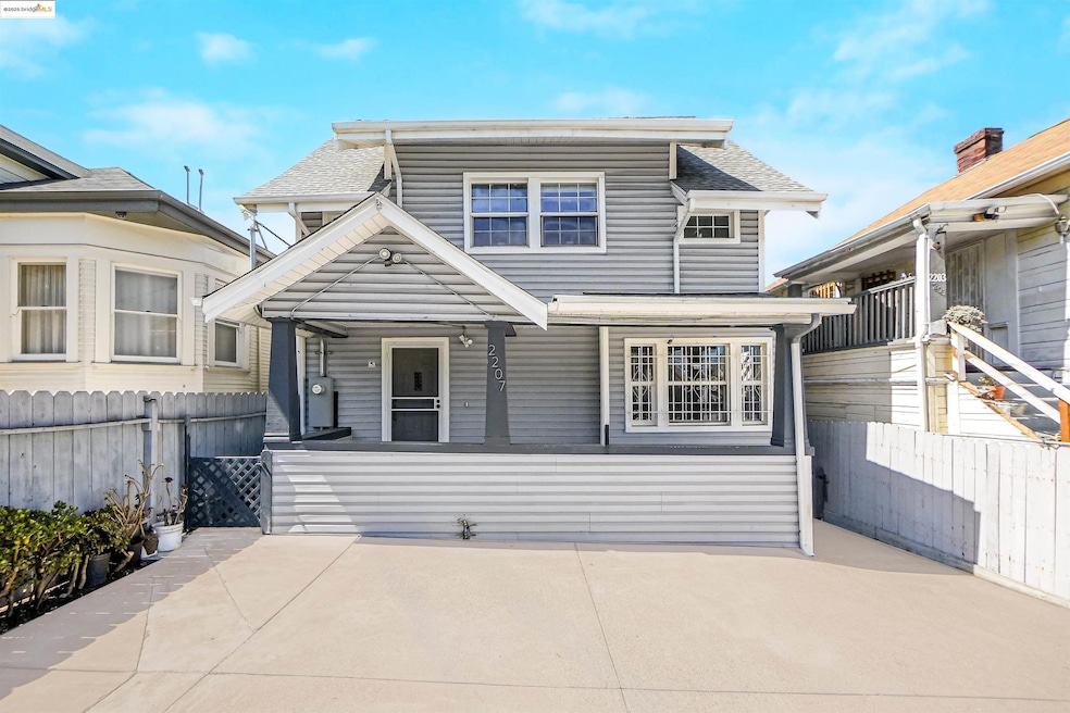 View of front facade featuring roof with shingles and covered porch