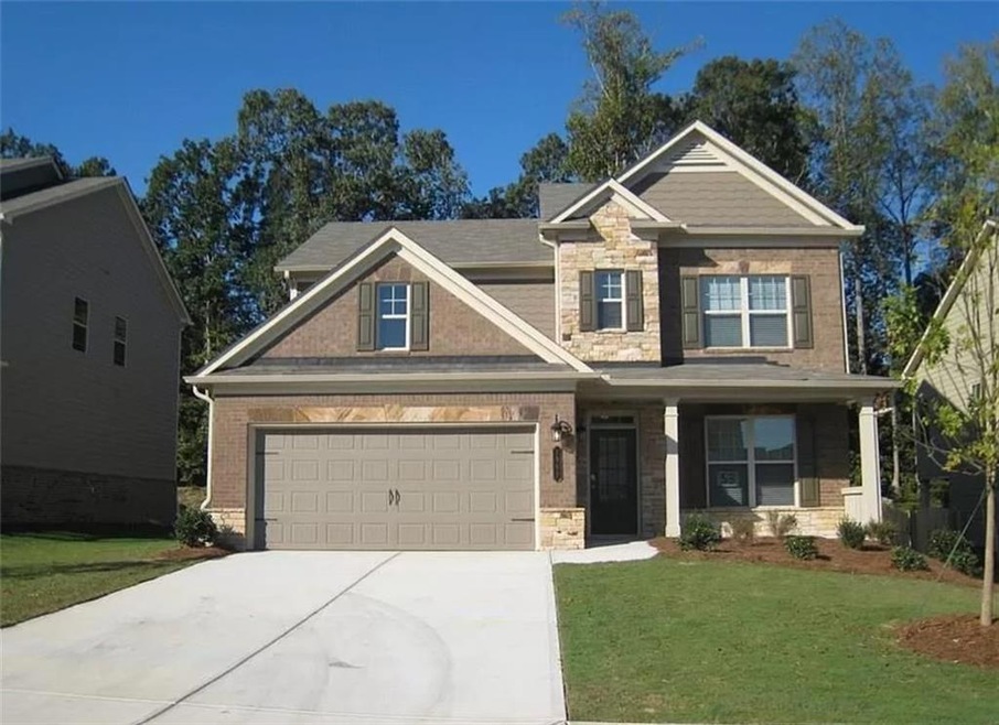 Craftsman house with a front lawn and a garage