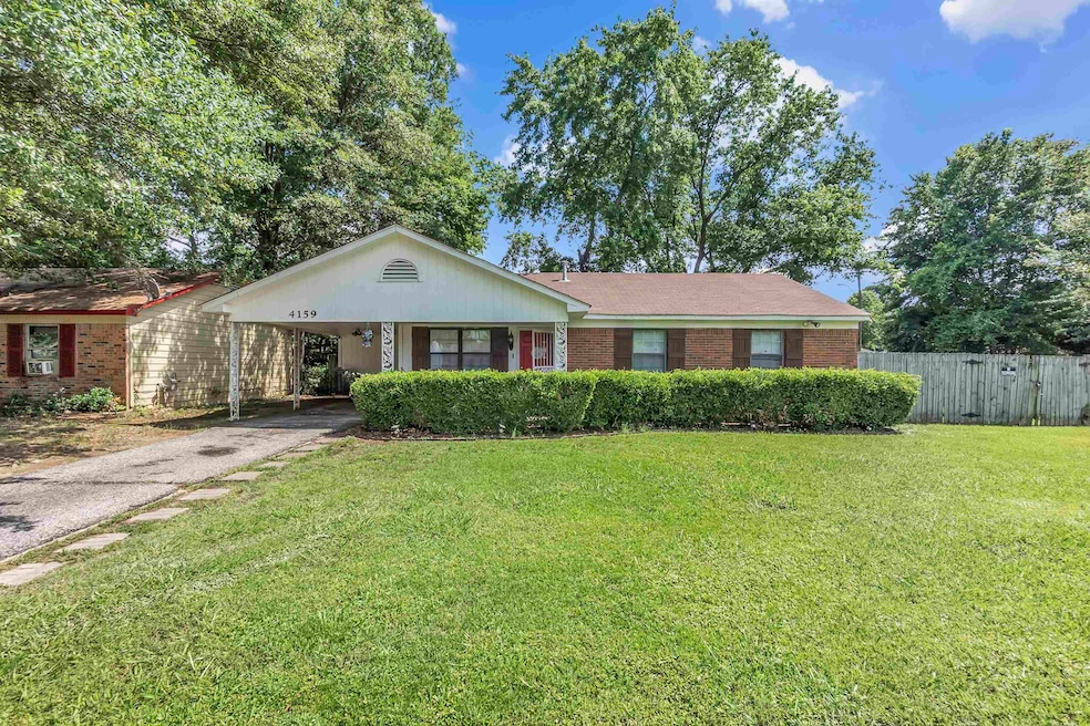 Ranch-style home featuring asphalt driveway, brick siding, and an attached carport