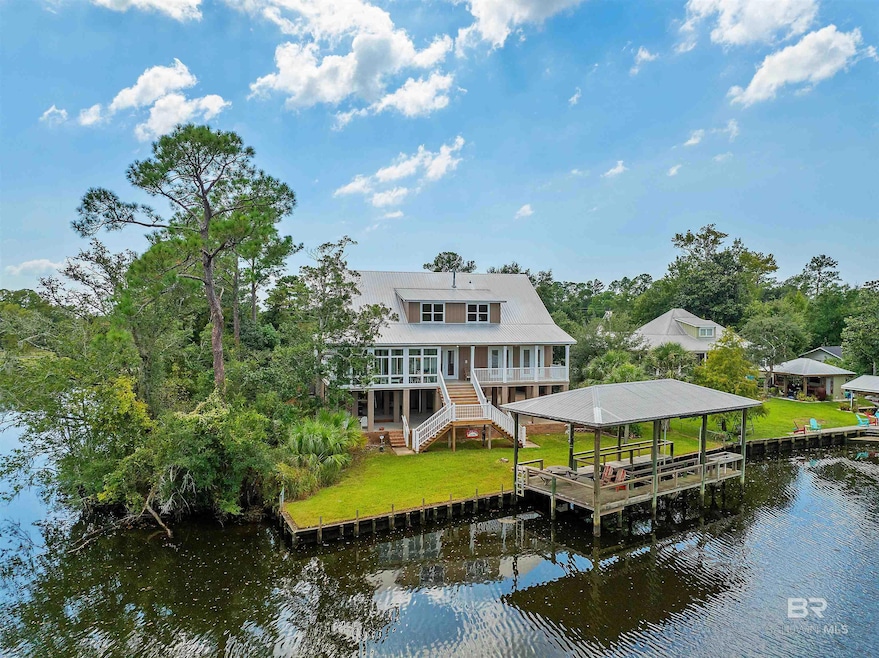 Dock area with a yard and a water view