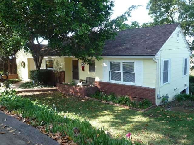 Brick pathways lead to the front door.